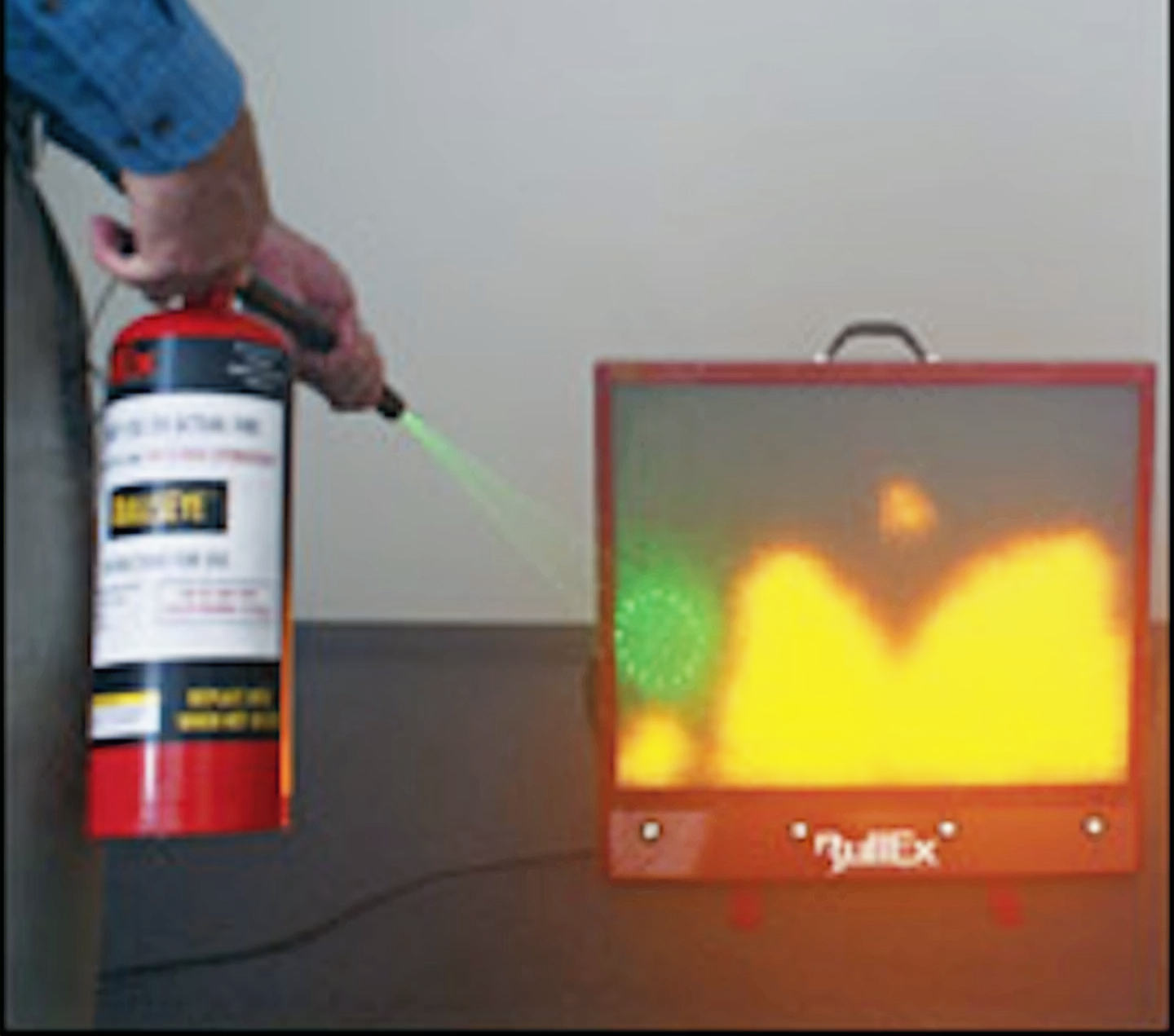 A person using a digital fire extinguisher at a training display